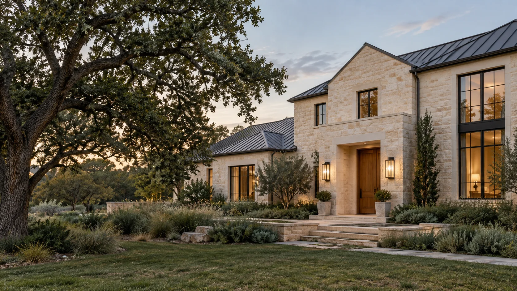 Illustrative limestone home framed by mature live oaks